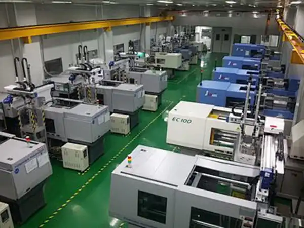 Operator performing CNC quality check using caliper to measure machined aluminum parts
