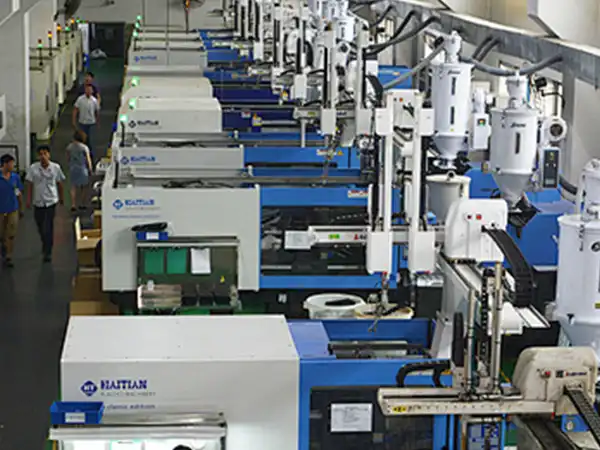 Operator performing CNC quality check using go/no-go gauge to verify hole dimensions of machined parts
